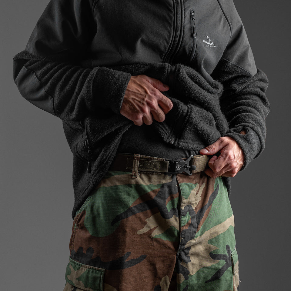 durable outdoors belt made in America. The Voyager Belt shown in green with camo pants.